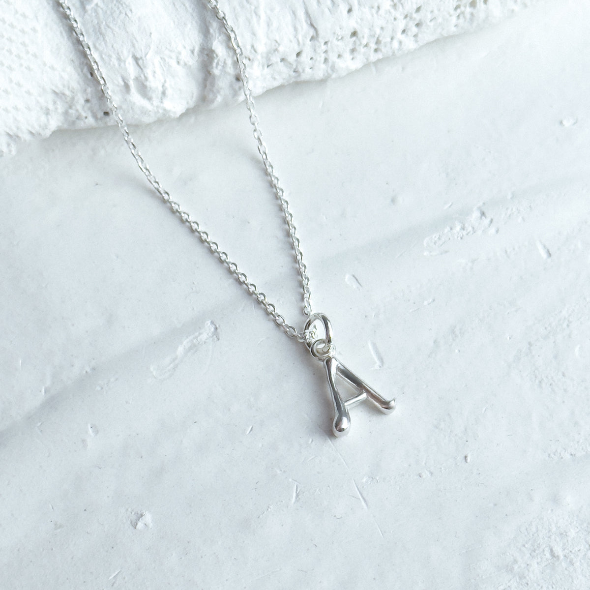 Yours Truly Initial, the sterling silver letter A shown close up