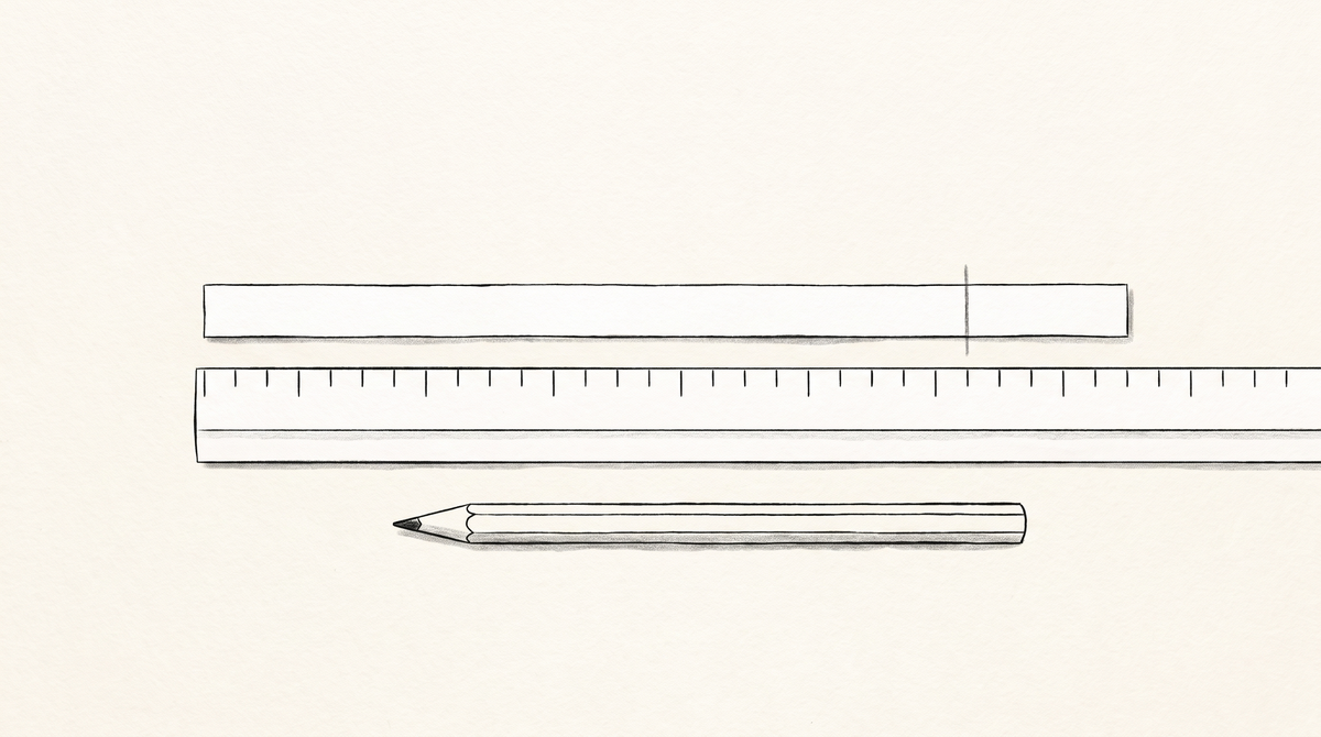 The marked strip laid flat against a ruler