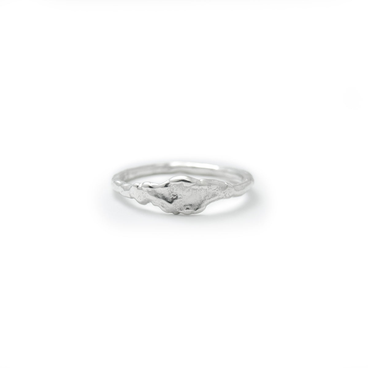 Molten Light Ring, a very slim sterling silver stacking band with a small molten detail