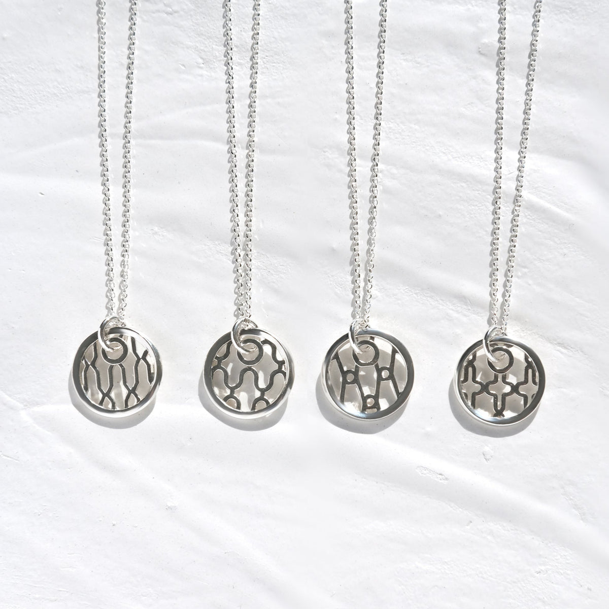 Helix Sentinel Necklace, round sterling silver openwork pendant on its chain