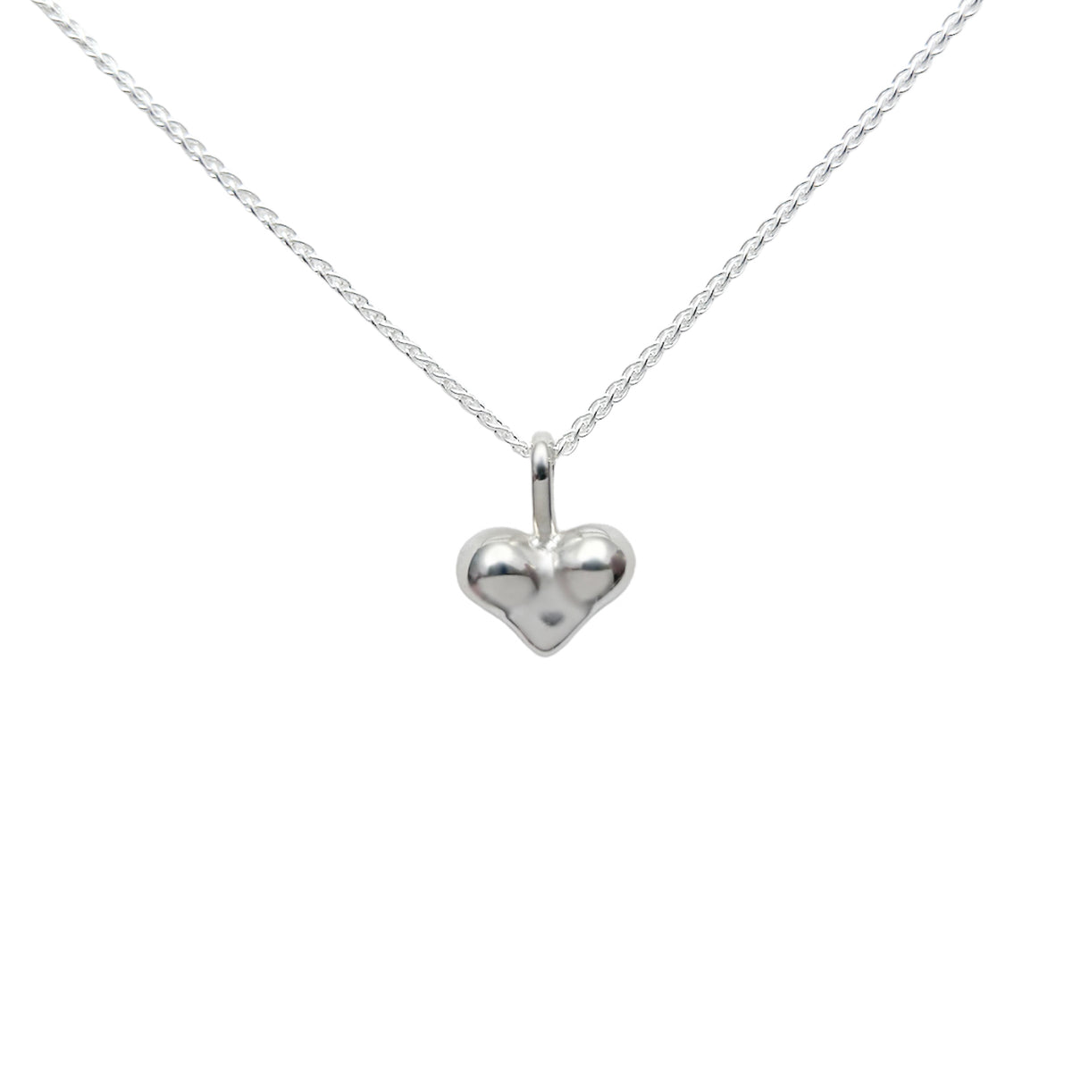 Cheeky Heart Necklace, a small puffed sterling silver heart pendant on a fine silver chain
