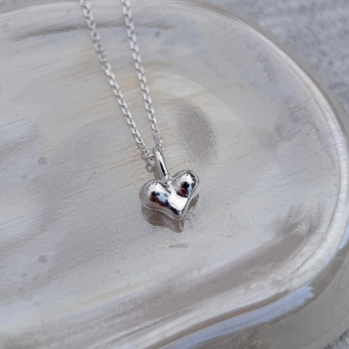 Cheeky Heart Necklace, small sterling silver heart seen from another angle